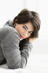 Germany, Bavaria, Munich, Portrait of young woman relaxing, smiling - SPOF000383