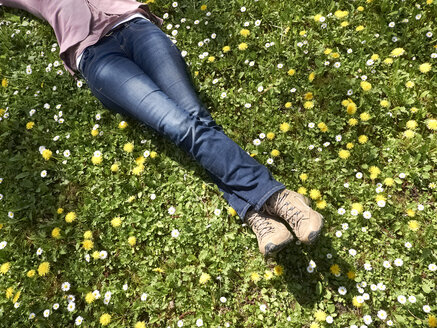 Germany, Hesse, Mature woman lying on meadow - BSCF000277