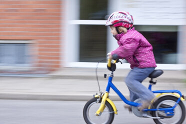 Germany, Kiel, Girl riding bicycle - JFEF000098