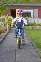 Germany, Kiel, Girl riding bicycle - JFEF000099