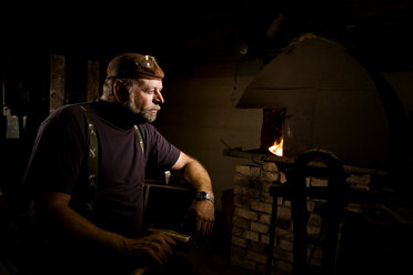 Blacksmith in workshop lost in thought - CNF000078