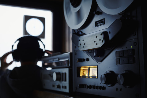 Germany, Bavaria, Man with head phone in recording studio stock photo