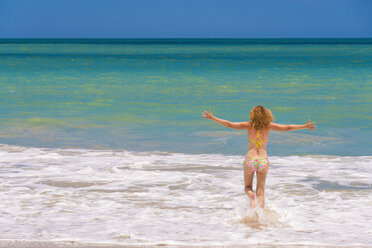 USA, Florida, Mature woman running on beach - ABAF000857