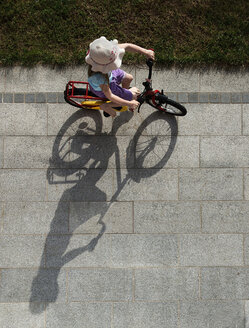 Austria, Girl cycling on street - CWF000053