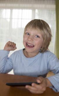 Austria, Boy playing with mobile phone - CWF000048