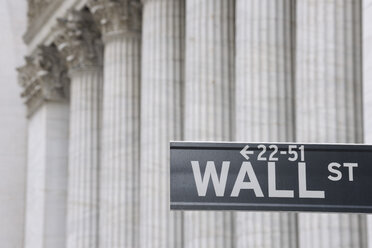 USA, New York State, Manhattan, Wall street sign against Stock Exchange pillars - RUEF001035