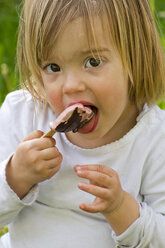 Germany, Girl eating popsicle ice cream, close up - LVF000076