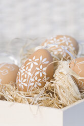 Painted easter eggs in box with straw - ASF004953