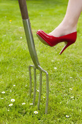 Germany, Brandenburg, Mid adults woman with high heels and fork - BFRF000224