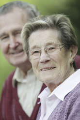 Germany, Cologne, Portrait of senior couple in park, smiling - JAT000042