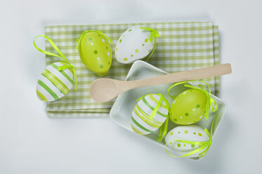 Easter eggs with napkin, wooden spoon on white background - ASF004977