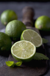 Limes with leaves and sickle, close up - CSF019346