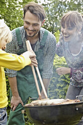 Germany, Cologne, Family having barbecue, smiling - RHYF000450