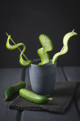 Skewers with cucumber slices in cup, close up - ECF000191