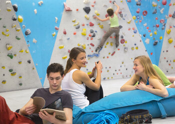 Friends relaxing together, indoor climbing - HSIYF000239