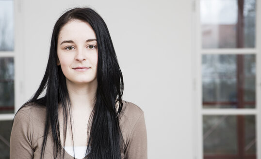 Austria, Young woman with black hair at schoo - DISF000071