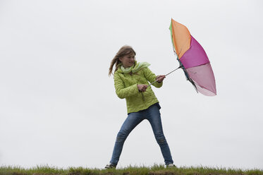 Germany, Bavaria, Starnberg, Girl fighting with rough weather - CRF002426