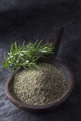 Wooden spoon with rosemary on textile, close up - CSF019500