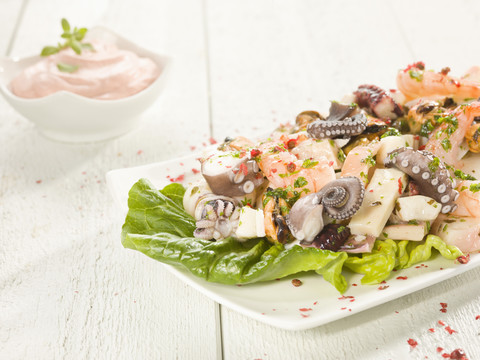 Octopus salad with cocktail sauce stock photo