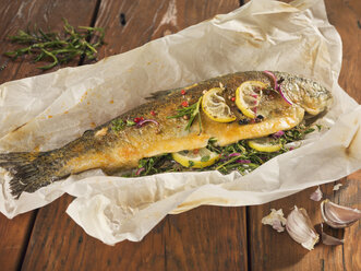 Fried trout stuffed with herbs on wooden plank - CH000026