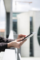 Germany, Berlin, Businesswoman using digital tablet, close up - FKIF000019