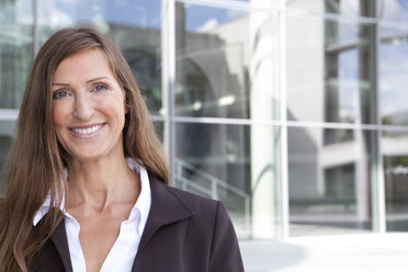 Germany, Berlin, Portrait of businesswoman, smiling - FKIF000032