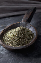 Variety of Italian herbs and powder in wooden spoon, close up - CSF019545