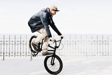 Germany, Schleswig Holstein, Teenage boy jumping with BMX bike - MSF002941