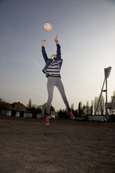 Germany, Berlin, Teenage girl catching football - TKF000137