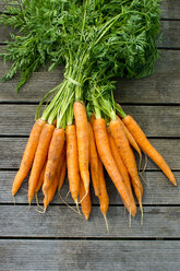 Bunch of Carrots on wooden table - LV000099