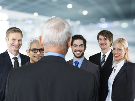 Businessmen and businesswoman talking, smiling - STKF000291