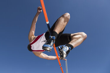 Germany, Mature man curling over high jump - STSF000015