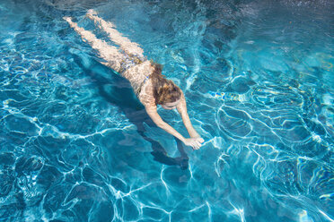 Junge Frau schwimmt im Pool - ABAF000899