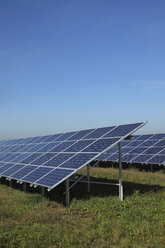 Germany, Bavaria, Solar panels on grass against sky - RDF001039