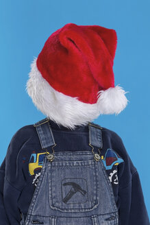 Junge bedeckt Gesicht mit Weihnachtsmannmütze - RDF001112