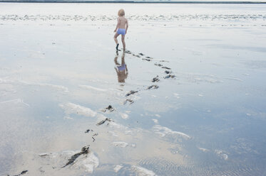 Deutschland, Schleswig Holstein, Junge spielt im Schlamm am Strand - MJF000224