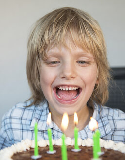 Austria, Boy laughing and looking at birthday cake, close up - CW000058