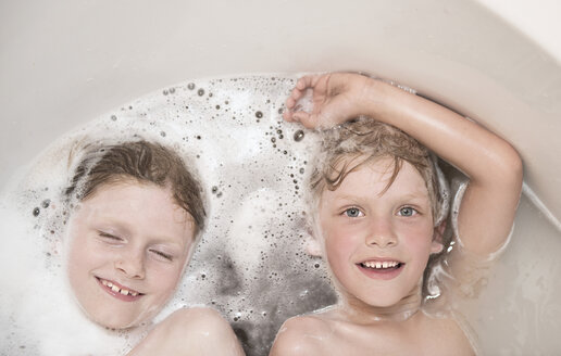 Austria, Boy and girl relaxing in bathtube, smiling - CW000060