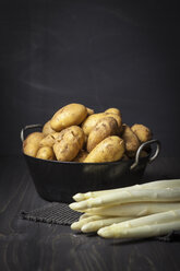 Potatoes and white asparagus on table, close up - ECF000225