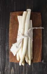 Bunch of white asparagus on chopping board - ECF000226