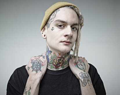 Portrait of young man with tattoos, close up - RH000257