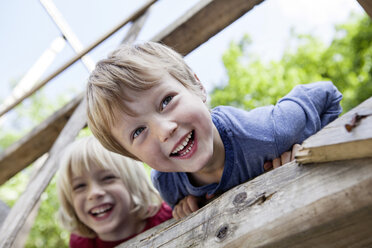 Germany, North Rhine Westphalia, Cologne, Boys playing in playground, smiling - FMKYF000406