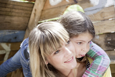 Germany, North Rhine Westphalia, Cologne, Mother and daughter embracing each other, smiling - FMKYF000369