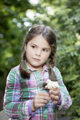 Germany, North Rhine Westphalia, Cologne, Girl holding flower - FMKYF000365