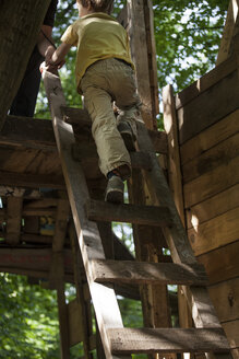 Germany, North Rhine Westphalia, Cologne, Boy climbing up steps - FMKYF000453