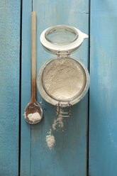 Jar of flour with wooden spoon on table - OD000116