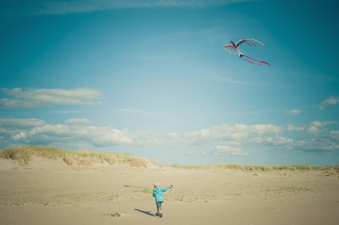 Dänemark, Romo, Junge lässt Drachen an der Nordsee steigen, lizenzfreies Stockfoto