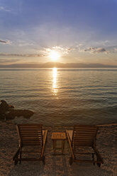 Croatia, Krk, Sunbeds at sunset in Njivice - GFF000051