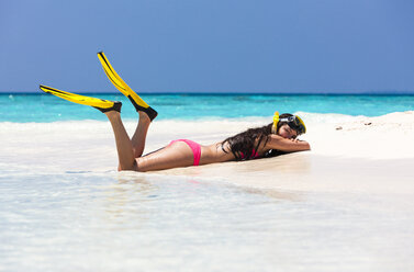 Maldives,Young woman lying in beach - AMF000634