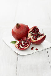 Pomegranates on wooden table, close up - KSWF001157